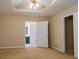 Bedroom featuring tray ceiling, fan and a doorway to the Primary bath at 110 Fox Meadow Dr, Covington, GA 30016