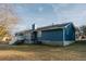 Exterior of the home showcasing blue siding, a white porch, and a spacious backyard for entertainment and relaxation at 110 Fox Meadow Dr, Covington, GA 30016