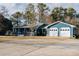 Lovely blue home with an attached two-car garage and a spacious driveway at 110 Fox Meadow Dr, Covington, GA 30016