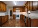Spacious kitchen with wood cabinets, granite countertops, and stainless steel appliances at 110 Fox Meadow Dr, Covington, GA 30016