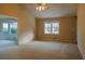 Open living room with vaulted ceiling, large windows, and carpet flooring at 110 Fox Meadow Dr, Covington, GA 30016