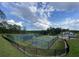 Community tennis court and basketball court surrounded by green grass and tall green trees at 117 Oliver Dr, Locust Grove, GA 30248