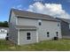 The back exterior features gray siding, a well-maintained lawn, and a concrete foundation at 117 Oliver Dr, Locust Grove, GA 30248