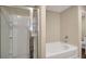 Bathroom showcasing a glass shower and soaking tub with clean, white tile and modern fixtures for a fresh aesthetic at 117 Oliver Dr, Locust Grove, GA 30248
