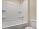 Clean bathroom featuring a modern, built-in tub and shower combo, plus a toilet at 117 Oliver Dr, Locust Grove, GA 30248