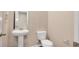 Half bathroom features pedestal sink, white toilet, and modern fixtures at 117 Oliver Dr, Locust Grove, GA 30248