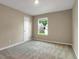 Bedroom showcasing natural light from the window and neutral tones for a comfortable living space at 117 Oliver Dr, Locust Grove, GA 30248