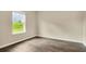Inviting bedroom with hardwood floors and a bright window overlooking the lawn at 117 Oliver Dr, Locust Grove, GA 30248