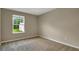 Neutral bedroom with window offering natural light and wall-to-wall carpet at 117 Oliver Dr, Locust Grove, GA 30248