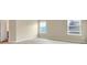Comfortable bedroom featuring neutral walls, plush carpeting, and windows for natural lighting at 117 Oliver Dr, Locust Grove, GA 30248