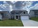 Charming two-story home features a well-maintained lawn, attached two car garage, and appealing modern exterior at 117 Oliver Dr, Locust Grove, GA 30248
