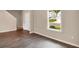 Bright living room with hardwood floors and large window at 117 Oliver Dr, Locust Grove, GA 30248