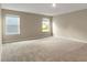 Spacious main bedroom with plush carpeting and large windows offering plenty of natural light at 117 Oliver Dr, Locust Grove, GA 30248