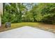 Large backyard featuring a concrete patio and lush greenery, offering a private outdoor space at 1382 Elizabeth Ln, Atlanta, GA 30344