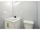Powder room featuring a modern vessel sink, sleek faucet, and toilet at 1382 Elizabeth Ln, Atlanta, GA 30344
