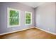 This bedroom offers great natural light through two windows and hardwood floors at 1382 Elizabeth Ln, Atlanta, GA 30344