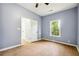 Bedroom with a ceiling fan, hardwood floors, neutral walls, and an entrance to another room at 1382 Elizabeth Ln, Atlanta, GA 30344
