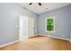 Well-lit bedroom with a large window, ceiling fan, and spacious closet at 1382 Elizabeth Ln, Atlanta, GA 30344