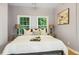 Bedroom features two windows, stylish lamps, a comfortable bed, and an elegant painting at 1382 Elizabeth Ln, Atlanta, GA 30344
