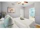 Comfortable bedroom showcasing natural light, complemented by a ceiling fan and calming wall art at 1382 Elizabeth Ln, Atlanta, GA 30344