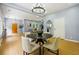 Open-concept dining area leading to the living room, with seating for four and natural light at 1382 Elizabeth Ln, Atlanta, GA 30344