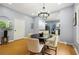 Cozy dining area with views into the kitchen, modern lighting and seating for four at 1382 Elizabeth Ln, Atlanta, GA 30344