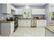 Well-lit kitchen features stainless steel appliances, granite countertops and ample cabinet space at 1382 Elizabeth Ln, Atlanta, GA 30344