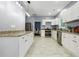 Well-lit kitchen boasts stainless steel appliances, granite countertops, and white cabinets at 1382 Elizabeth Ln, Atlanta, GA 30344