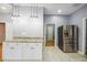 Bright kitchen with granite countertops, stainless steel refrigerator, and modern pendant lighting at 1382 Elizabeth Ln, Atlanta, GA 30344