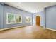Bright and airy living room with large windows and a rustic wooden door at 1382 Elizabeth Ln, Atlanta, GA 30344