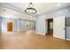 Bright living room with hardwood floors, modern chandelier, and natural light at 1382 Elizabeth Ln, Atlanta, GA 30344