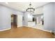 Spacious living room with hardwood floors, connecting to kitchen and another room at 1382 Elizabeth Ln, Atlanta, GA 30344