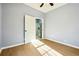 Bright room featuring wood-look flooring, fresh paint, and an open closet to a kitchen at 1382 Elizabeth Ln, Atlanta, GA 30344