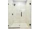 This renovated shower features marble tiling, glass doors, and modern fixtures at 1382 Elizabeth Ln, Atlanta, GA 30344
