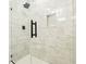 Bathroom with a modern walk-in shower featuring marble tiling and a sleek black fixture at 1382 Elizabeth Ln, Atlanta, GA 30344