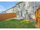 A backyard with a grass lawn, a small patio, and wood privacy fence at 2235 Mulsanne Dr, Lithonia, GA 30058