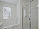 Bright bathroom featuring a glass enclosed shower, garden tub, and bright finishings at 2235 Mulsanne Dr, Lithonia, GA 30058