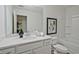 Bright bathroom features a vanity with a white countertop and a framed mirror at 2235 Mulsanne Dr, Lithonia, GA 30058
