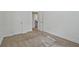 Carpeted bedroom has a door and closet; interior bathed in natural light at 2235 Mulsanne Dr, Lithonia, GA 30058
