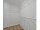 Walk-in closet with metal storage shelving, carpet flooring, and bright finishings at 2235 Mulsanne Dr, Lithonia, GA 30058