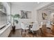 Dining area with hardwood floors, a round table, many chairs, and view of the green outdoors at 2235 Mulsanne Dr, Lithonia, GA 30058