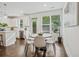 Eat-in kitchen area with hardwood floors, a round table, many chairs, and view of the green outdoors at 2235 Mulsanne Dr, Lithonia, GA 30058