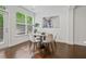 Bright dining area with hardwood floors, a round table, many chairs, and view of the green outdoors at 2235 Mulsanne Dr, Lithonia, GA 30058