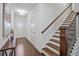 Hallway entrance with hardwood floors, a staircase and modern decor leading into the home at 2235 Mulsanne Dr, Lithonia, GA 30058