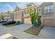 View of modern townhomes, driveways, attached garages, healthy lawns, and diverse architectural facades at 2235 Mulsanne Dr, Lithonia, GA 30058