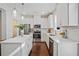 Contemporary kitchen with stainless steel appliances, white cabinetry, island, and wood floors at 2235 Mulsanne Dr, Lithonia, GA 30058