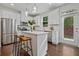 Modern kitchen with stainless steel appliances, white cabinetry, island, and wood floors at 2235 Mulsanne Dr, Lithonia, GA 30058