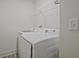 A laundry room is equipped with a washing machine and a dryer at 2235 Mulsanne Dr, Lithonia, GA 30058