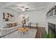 Bright living room features coffered ceilings, hardwood floors, modern furniture, and a cozy fireplace at 2235 Mulsanne Dr, Lithonia, GA 30058