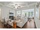 Bright living room features a fireplace, modern furniture, and open access to the kitchen and dining area at 2235 Mulsanne Dr, Lithonia, GA 30058